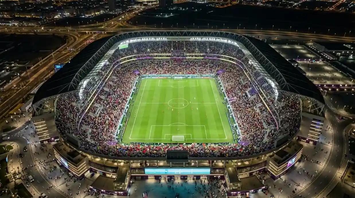 Widok z góry na rozświetlony stadion nocą z flagami narodowymi na trybunach